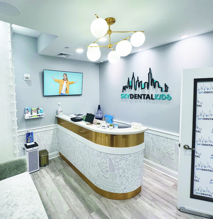 Clean, modern, white, gray, and blue lobby of Sky Dental Kids dental office.